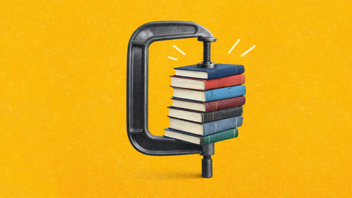 A stack of multicoloured books squeezed in a metal C-clamp on a textured yellow background