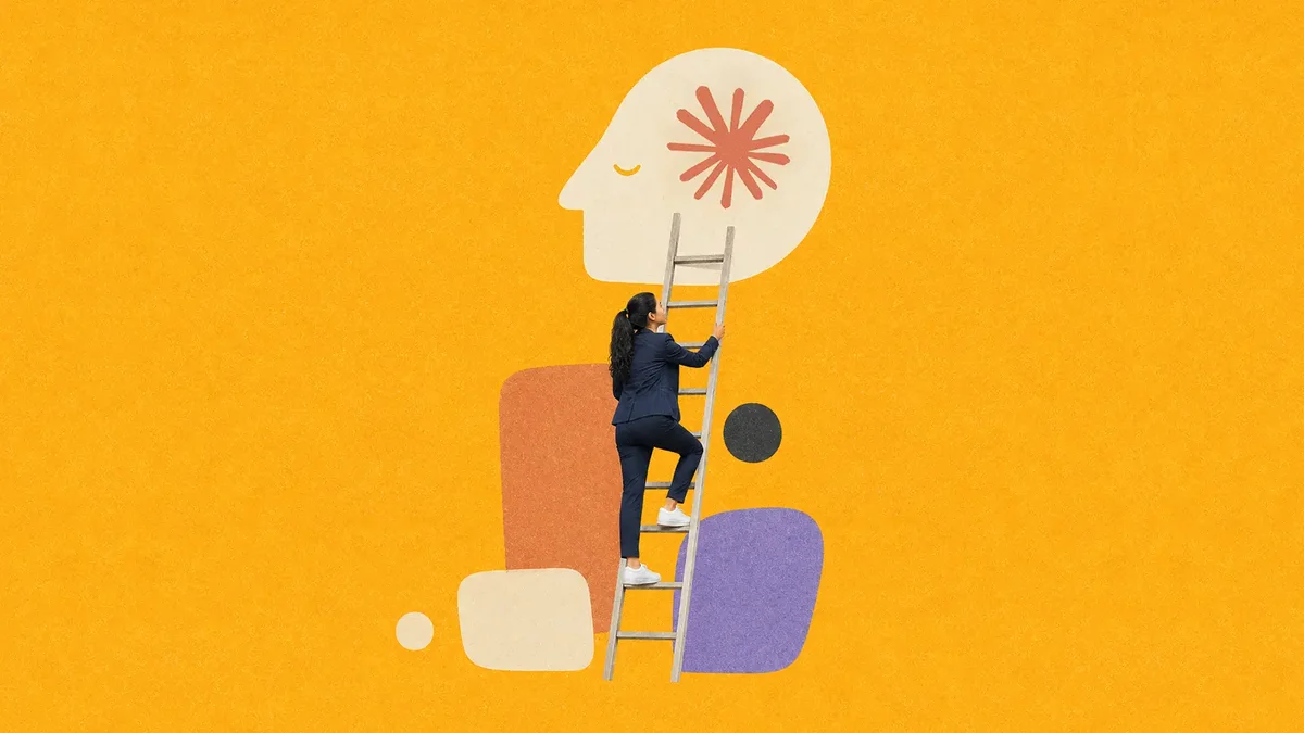 A woman in a navy suit climbing a wooden ladder toward a giant head silhouette containing a red starburst on a yellow background