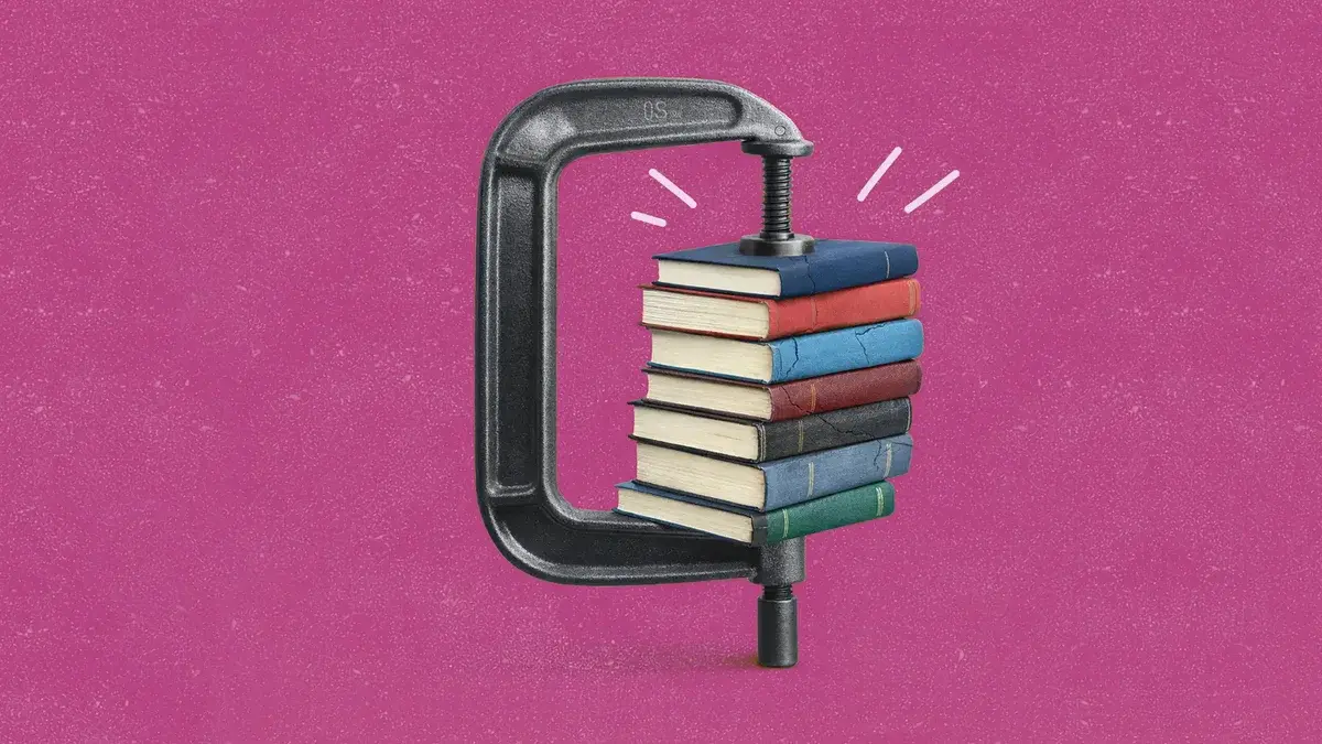 A stack of multicolored books squeezed in a metal C-clamp on a textured magenta background