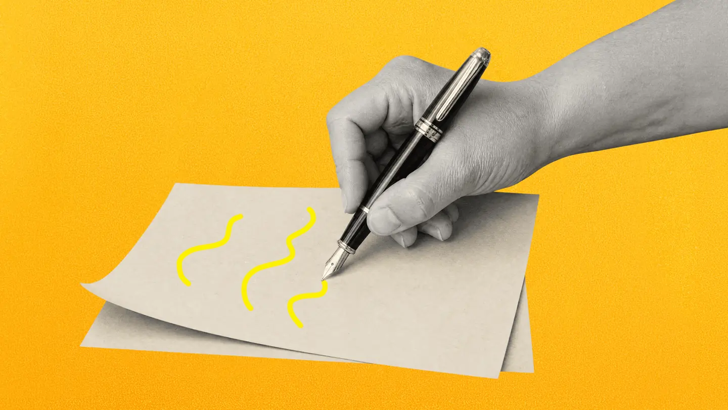 A hand holding a fountain pen drawing squiggles on a sheet of paper, on a yellow background
